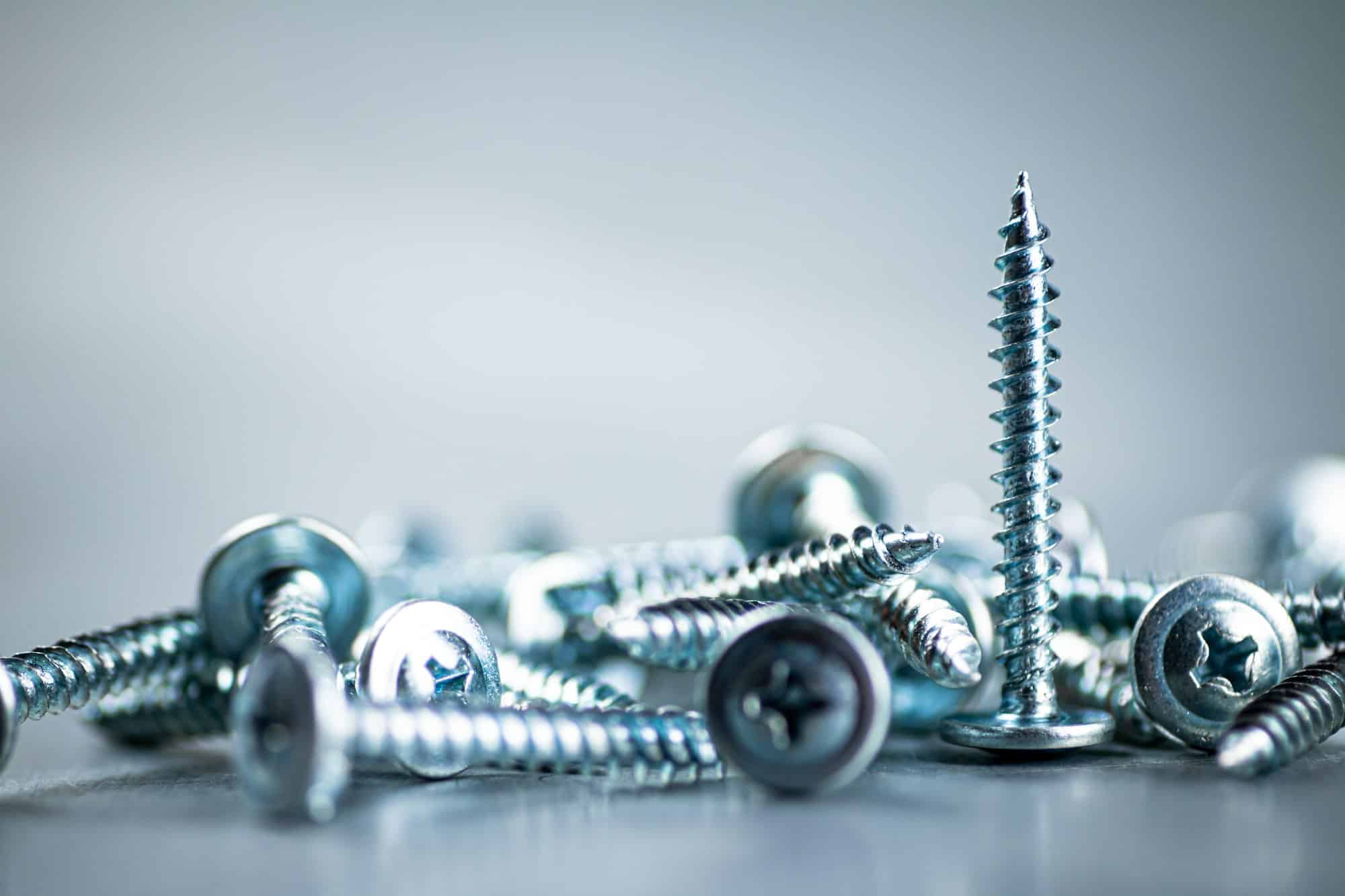 A bunch of self-tapping screws on the table.