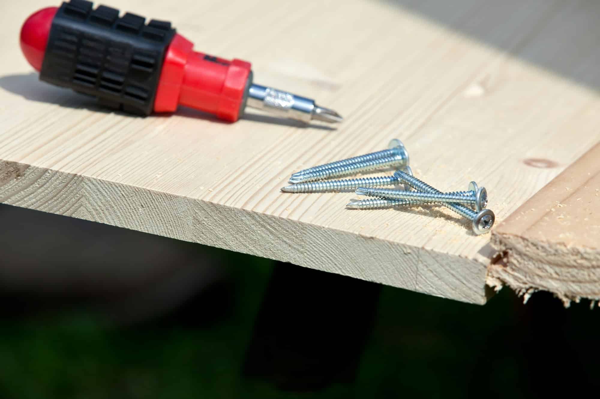 carpentry: screwdriver, screws and wood planks